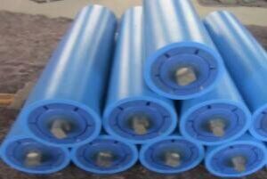 Conveyor idler rollers stacked in a yard